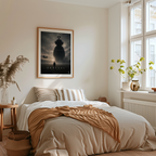 Bedroom with a bed, framed poster on the wall, and natural light coming through windows.