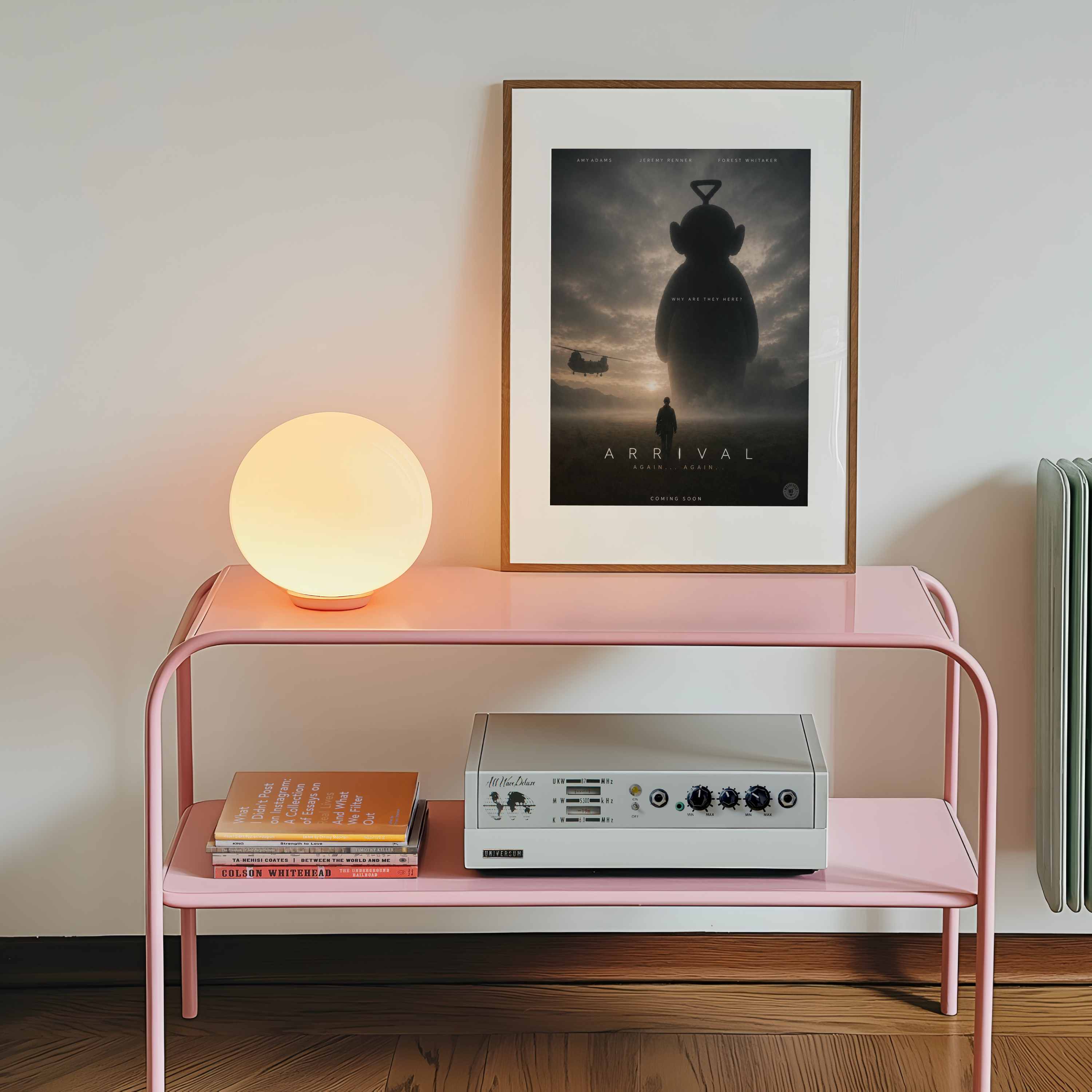 Pink side table with a lamp, books, and a framed movie poster on a wall.