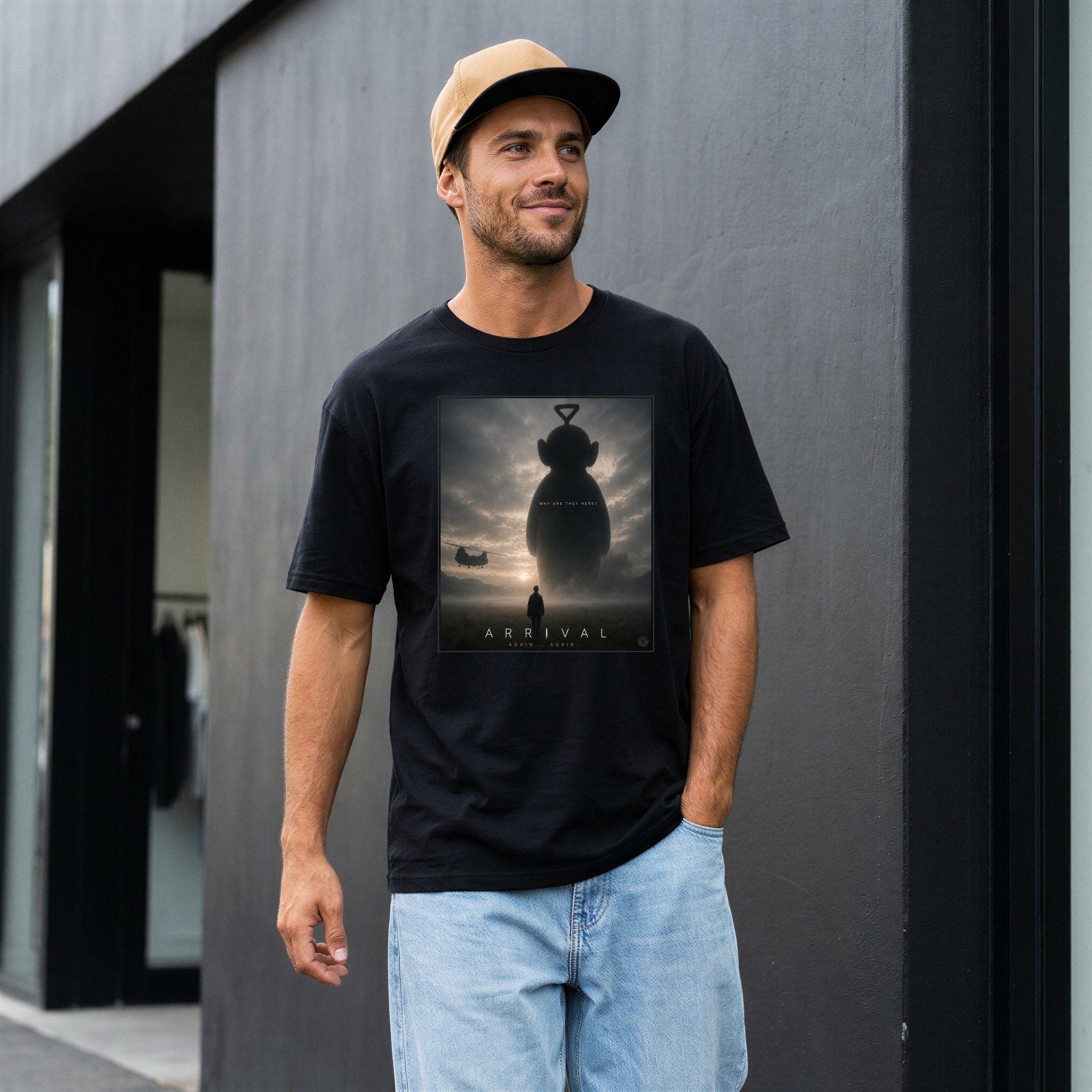 Man wearing a black t-shirt with a movie poster design, standing against a gray wall.
