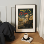 Framed poster of 'Better Call Paul' with an alien in a suit on a wooden surface with a cup and book.