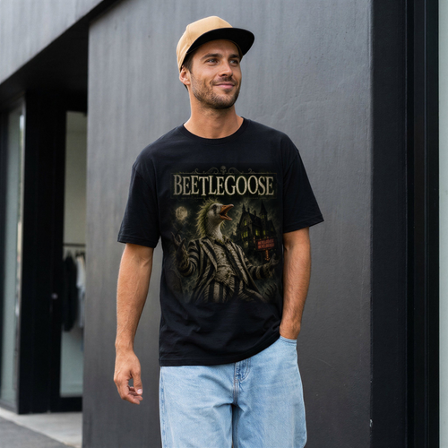 Man wearing a black t-shirt with 'BEETLEGOOSE' graphic design against a gray wall.