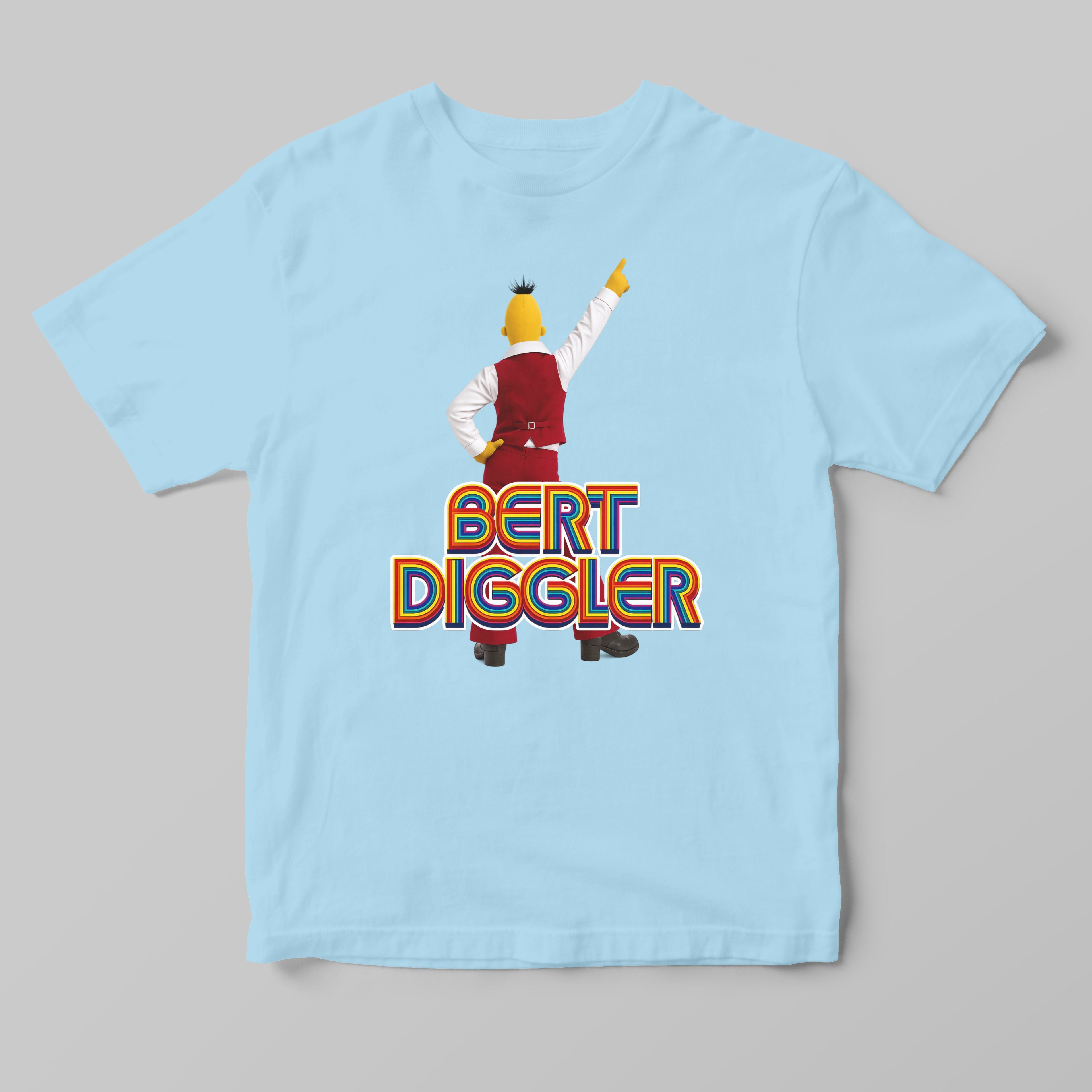 A light blue short-sleeve t-shirt featuring a graphic of the character Bert Diggler in a dabbing pose above the text 'BERT DIGGLER' in orange and yellow.