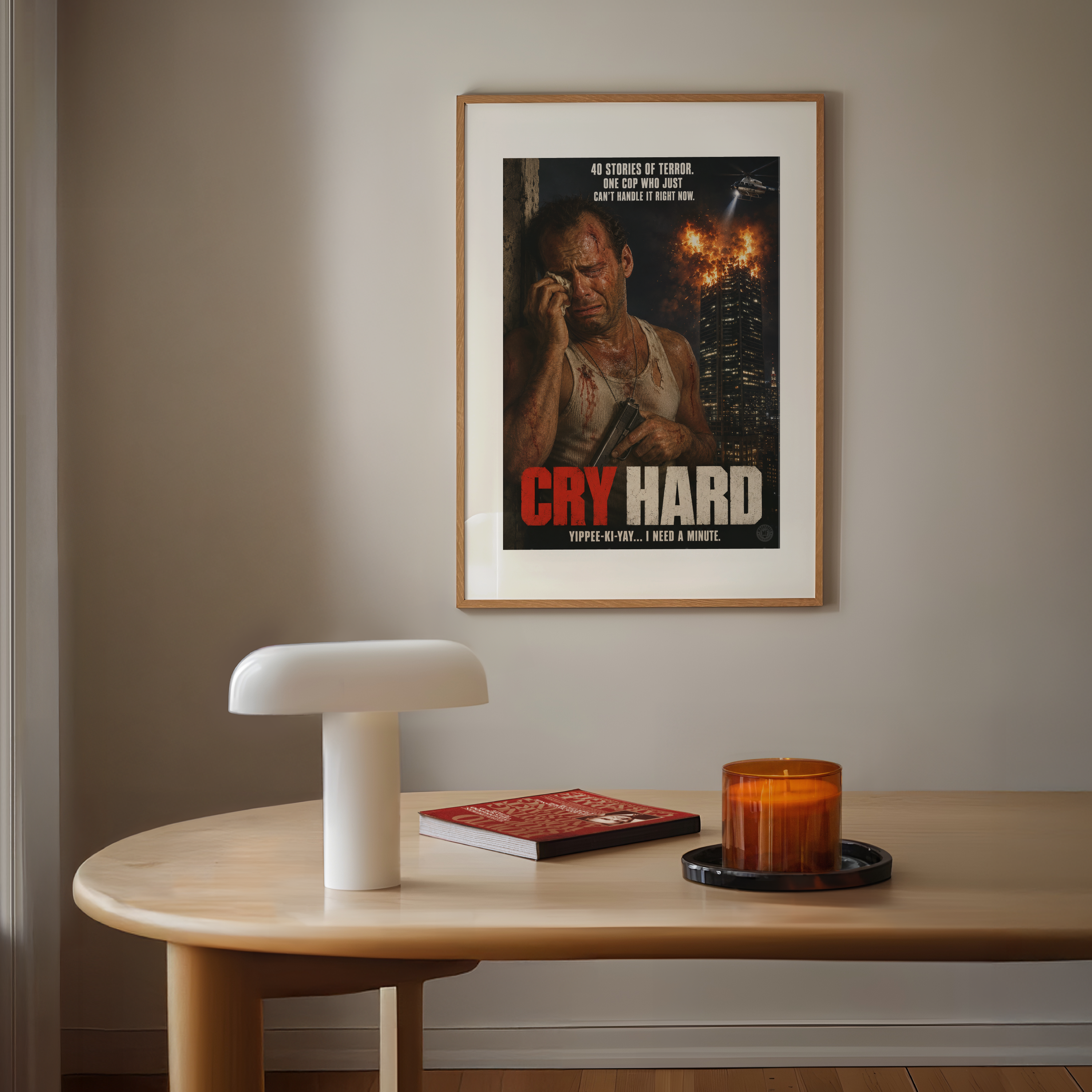 Framed movie poster titled 'Cry Hard' on a wall above a table with a lamp and candle.