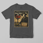 A grey black tshirt with a funny graphic there will be cud cow print
