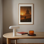 Framed 'Dune' teletubby parody movie poster on a wall above a wooden table with decor items.