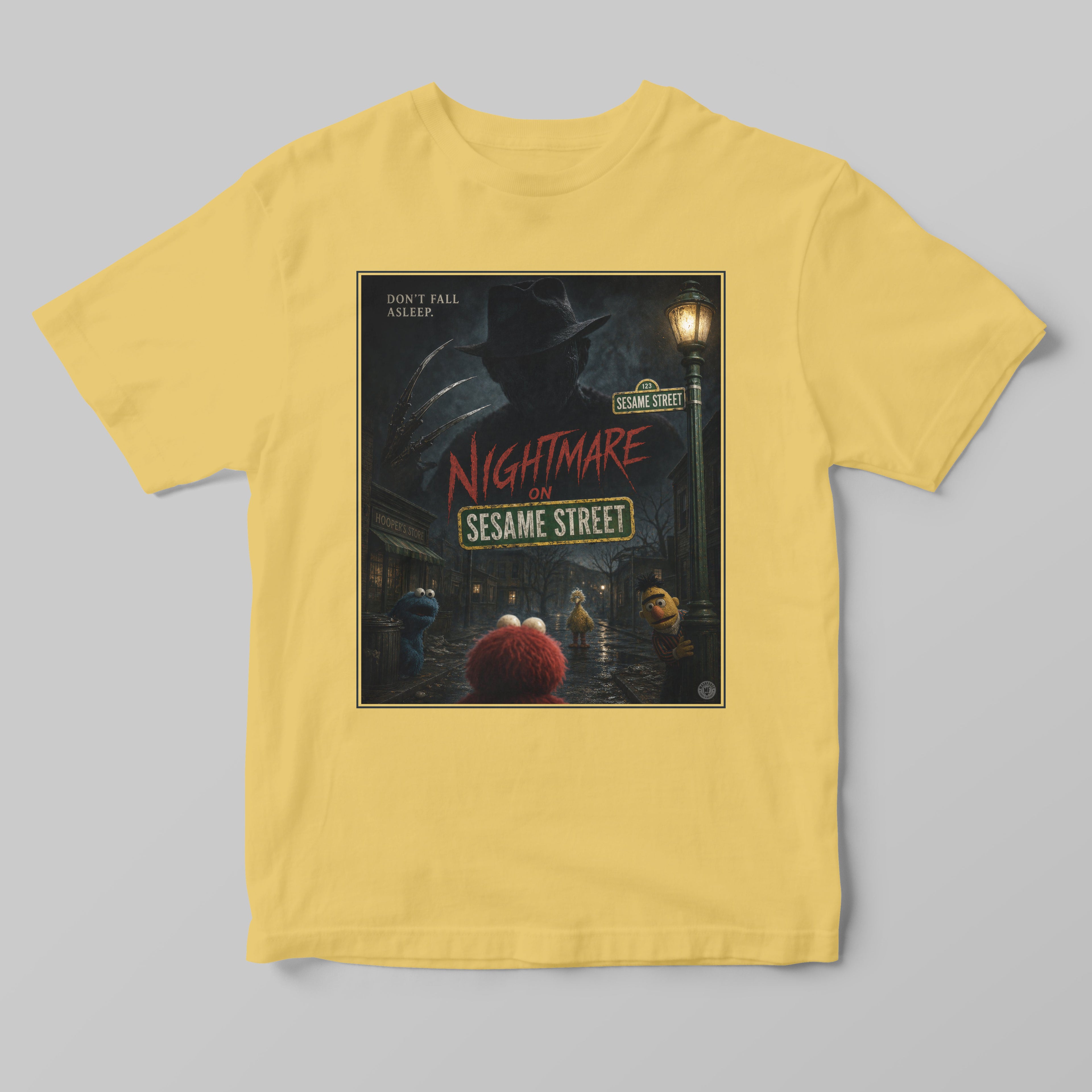Yellow t-shirt with 'Nightmare on Sesame Street' graphic design on a gray background