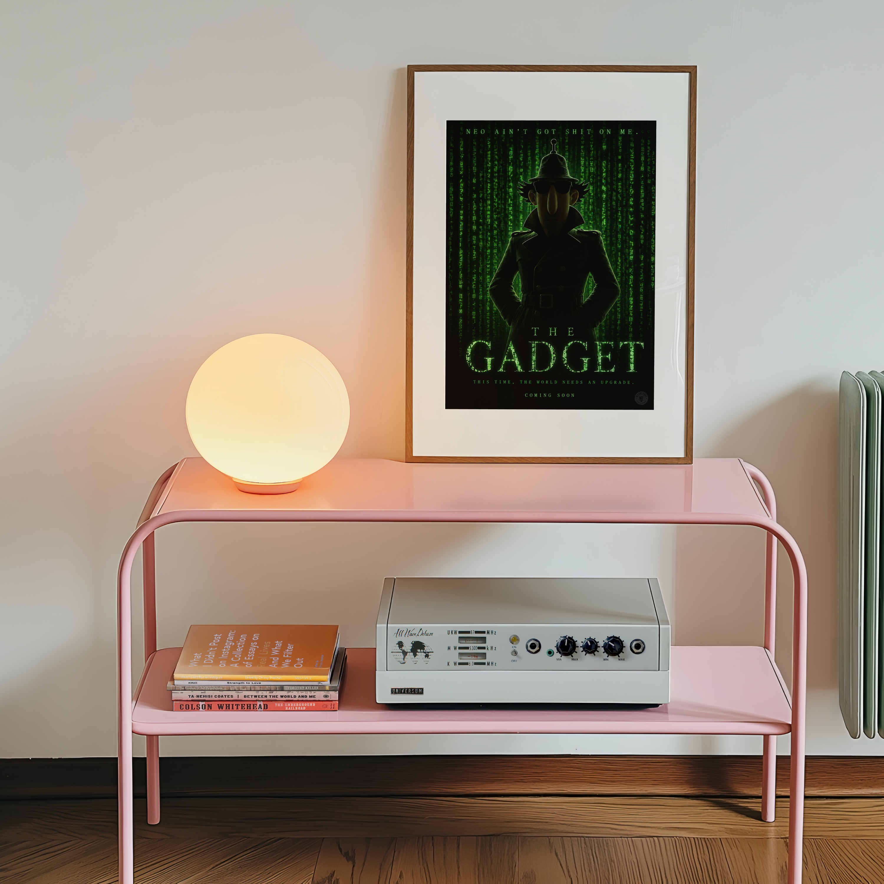 Pink shelf with a lamp, books, and a vintage radio player against a white wall with a framed inspector gadget matrix poster.