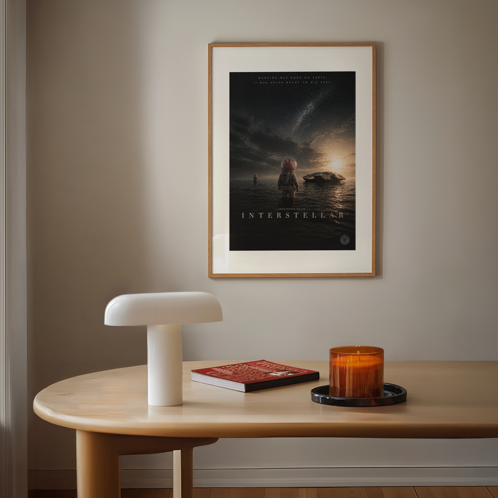 Framed 'Interstellar' cartoon pig movie poster on a wall above a wooden table with decor items.