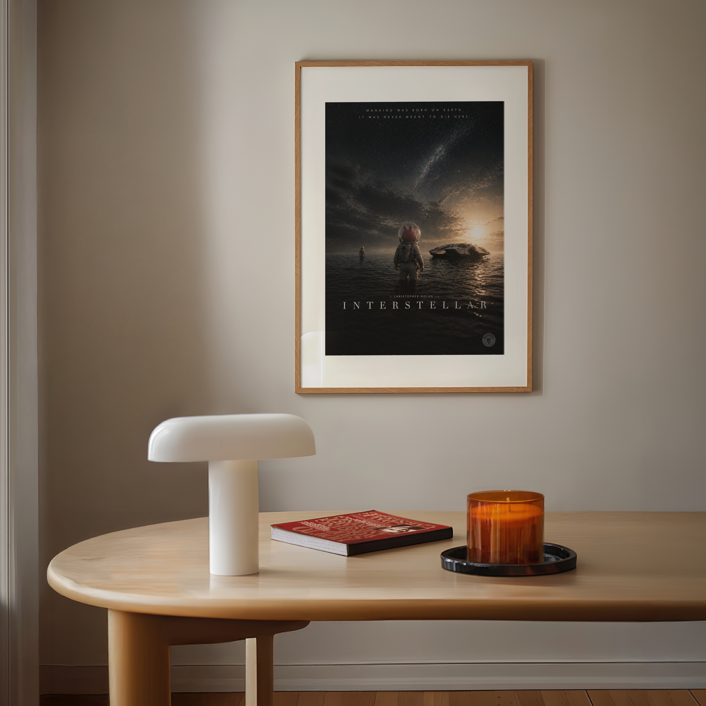 Framed 'Interstellar' cartoon pig movie poster on a wall above a wooden table with decor items.