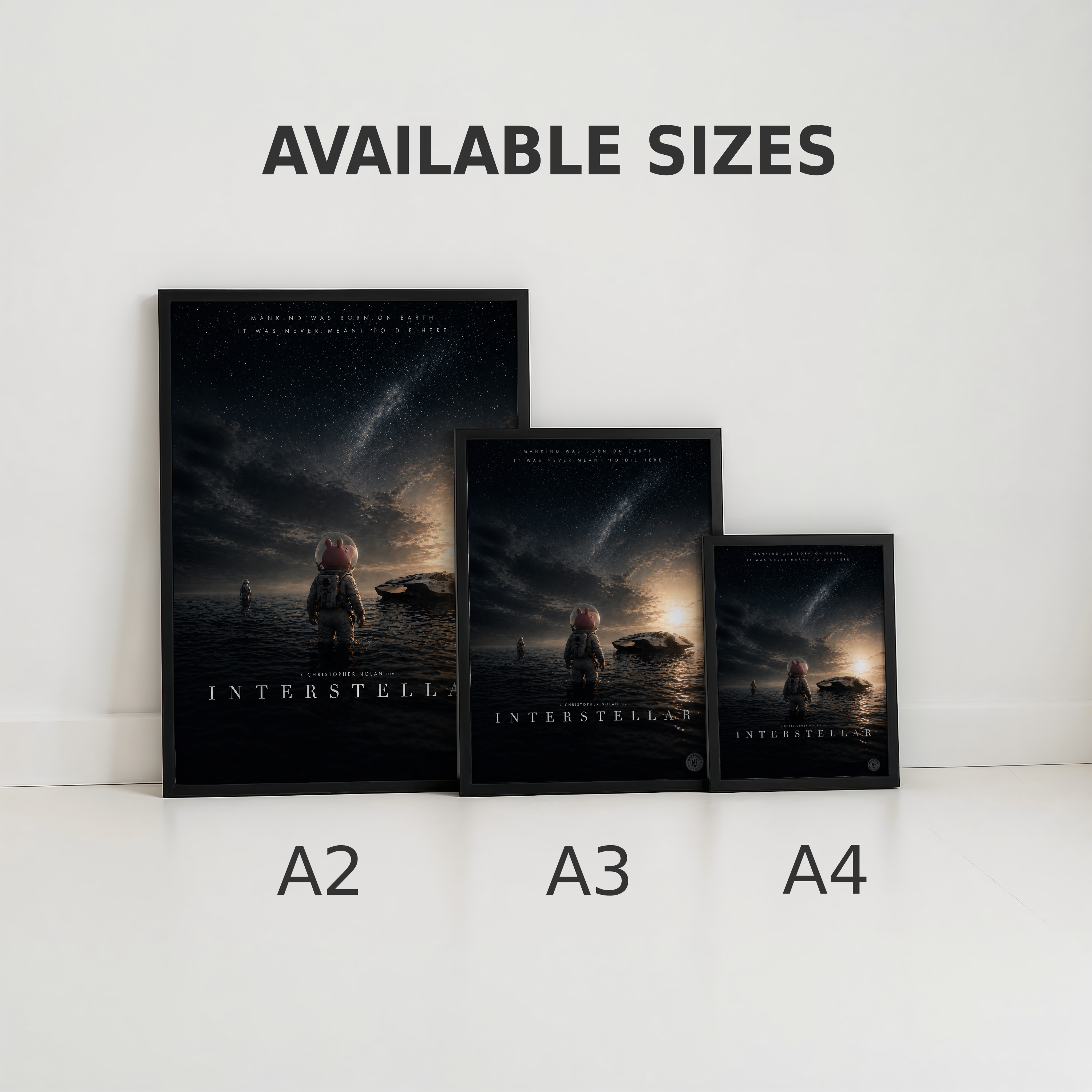 Three framed movie posters of 'Interstellar' in different sizes on a white surface.