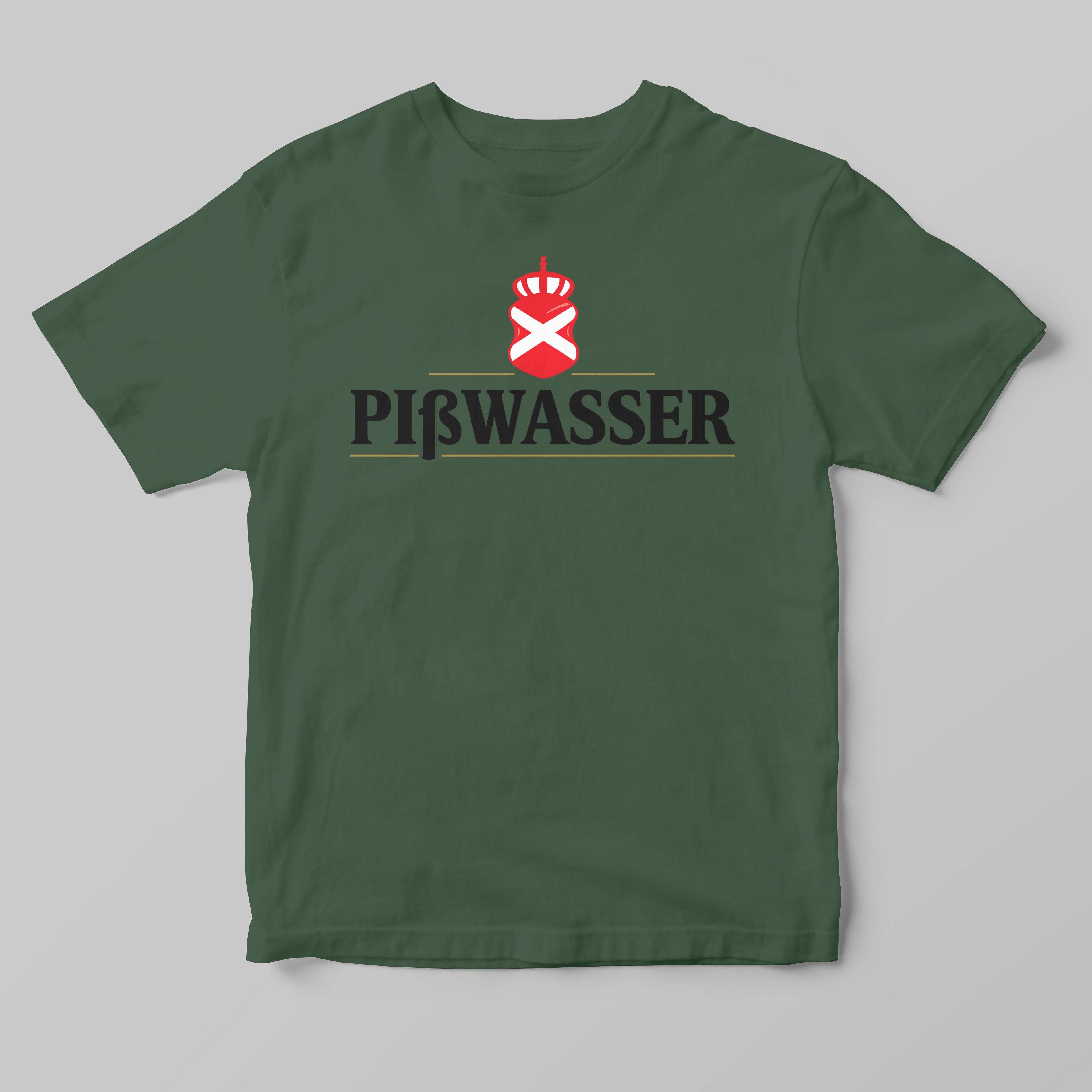 A dark green short-sleeve t-shirt with a 'PIßWASSER' graphic on the chest, featuring a red and white crown-and-cross emblem above black stylized lettering, displayed on a neutral gray background.
