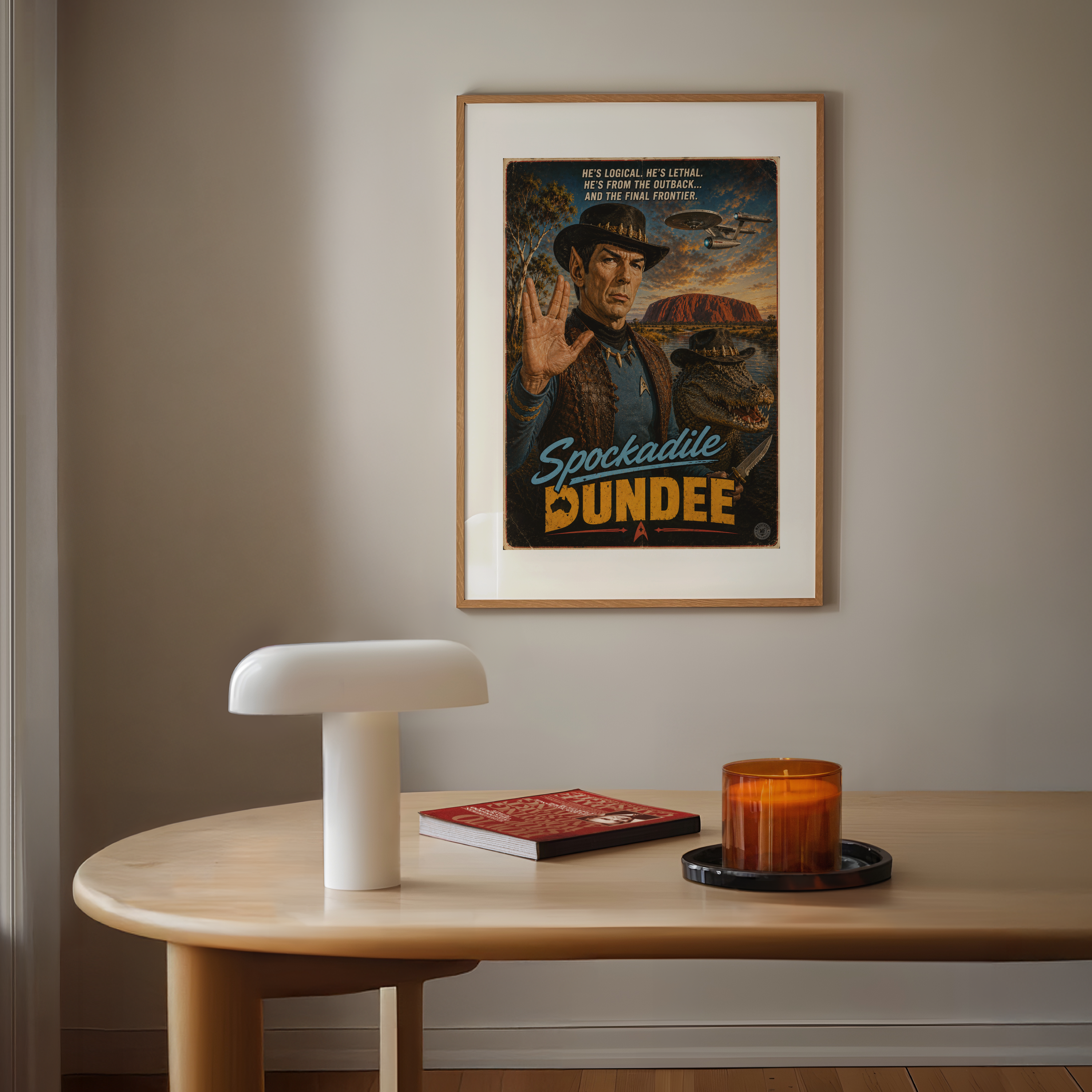 Framed poster of Spockidale Dundee on a wall above a wooden table with a lamp, book, and candle.