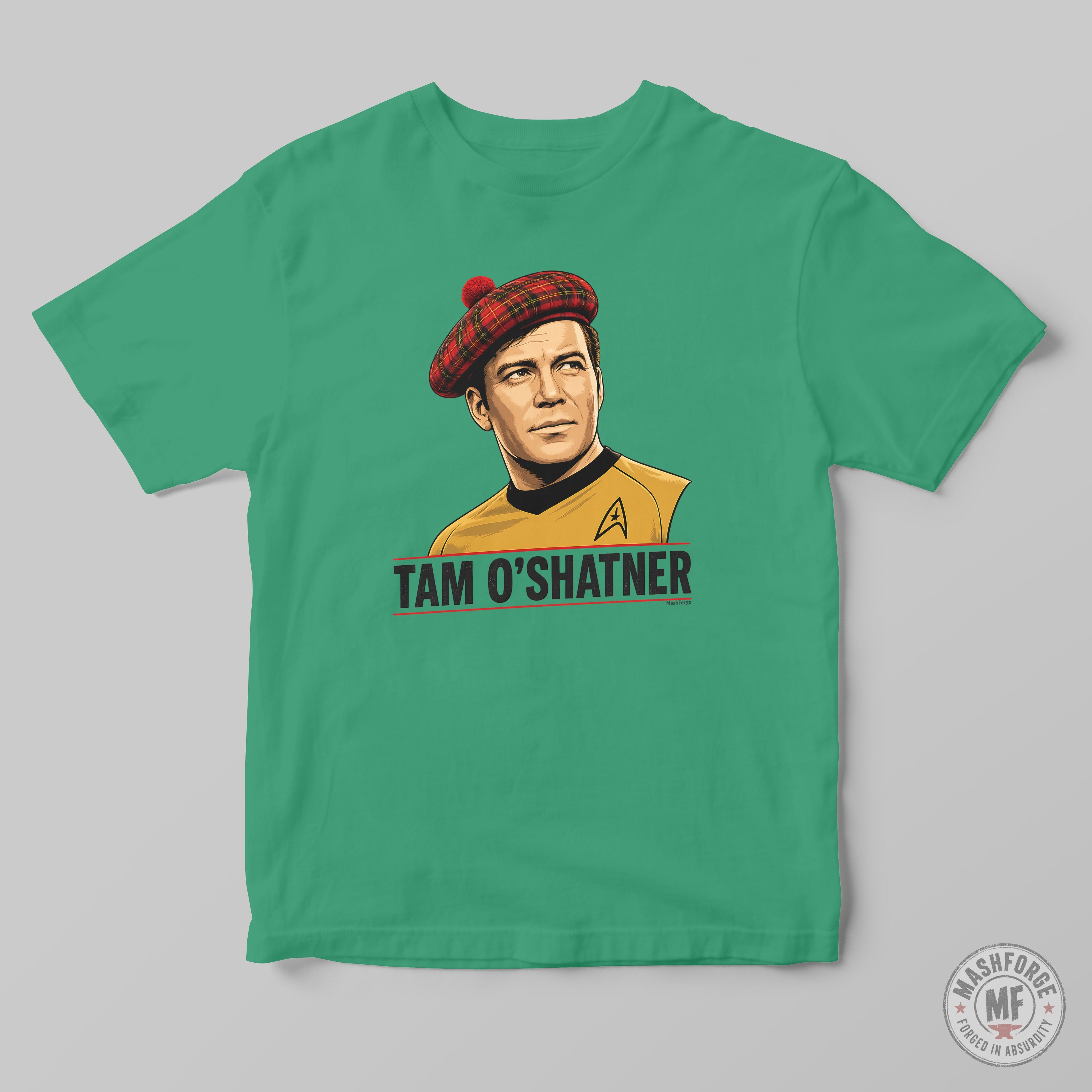 A green crewneck t-shirt featuring a graphic print of Captain Tam O'Shatner from Star Trek wearing a red tartan beret and a gold command uniform, with 'TAM O'SHATNER' printed below. The t-shirt is displayed flat against a neutral gray background.