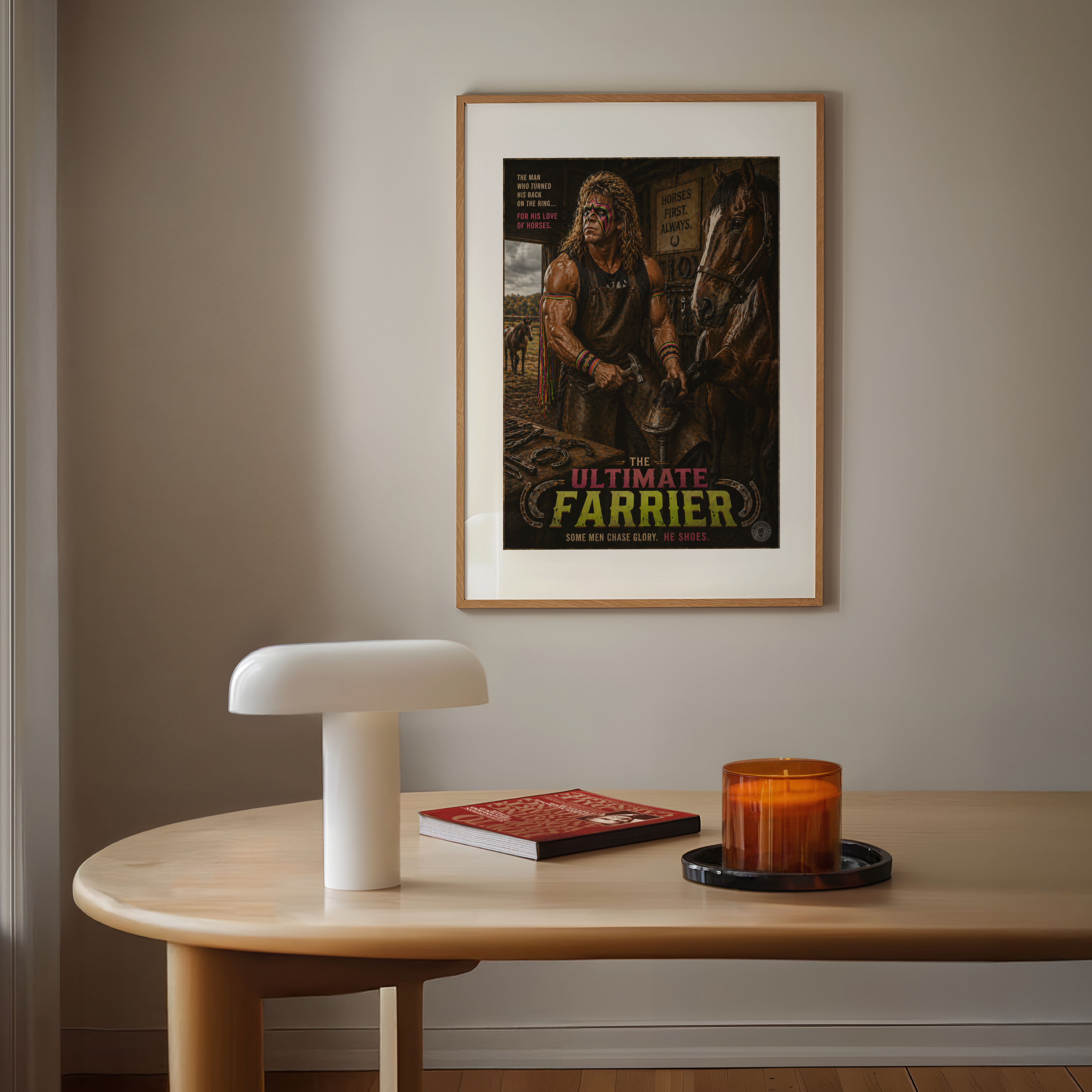 Framed poster of 'The Ultimate Farrier' on a wall above a wooden table with a lamp, book, and candle.