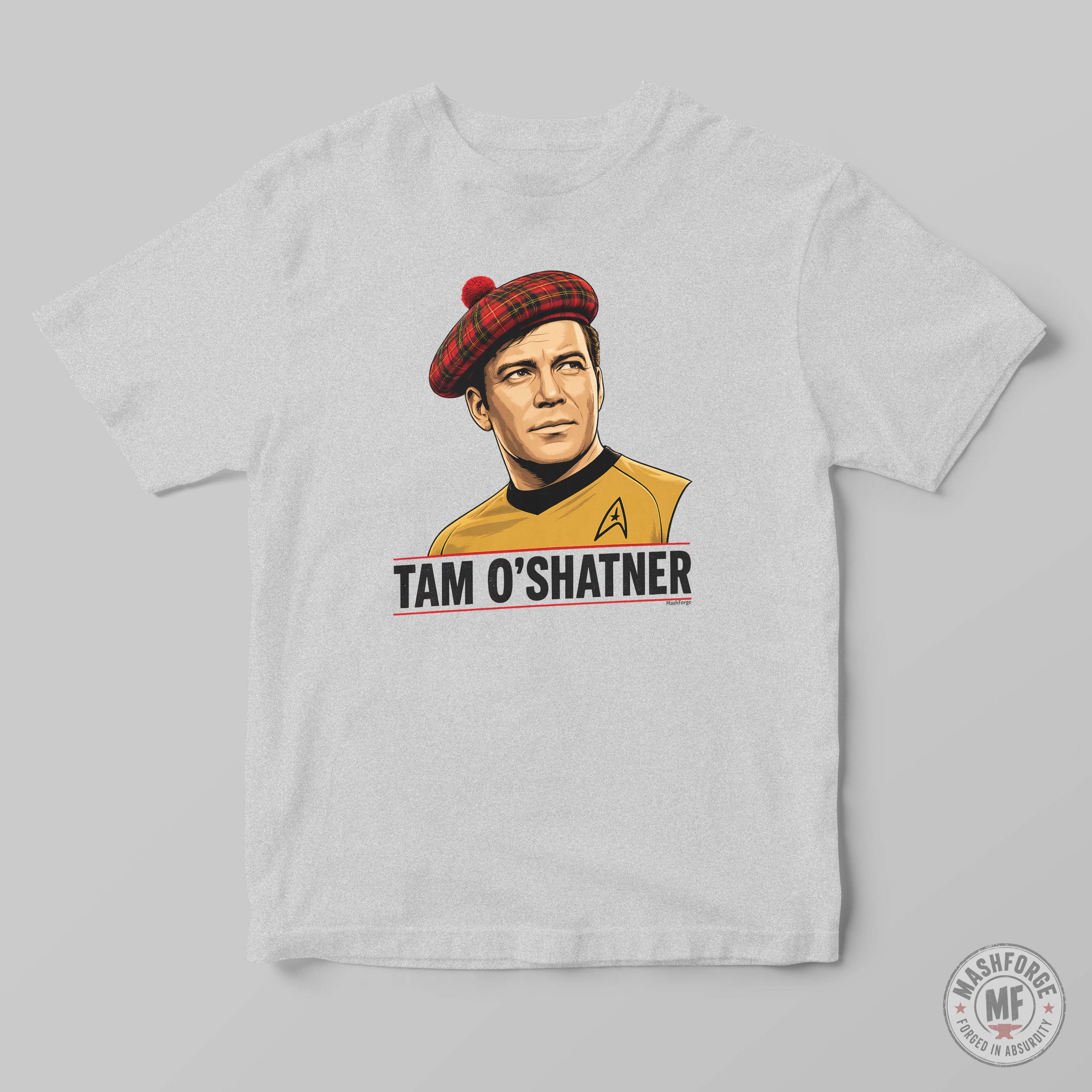 A light gray crewneck t-shirt featuring a graphic print of Captain Tam O'Shatner from Star Trek wearing his signature red tartan beret and yellow uniform, with the text 'TAM O'SHATNER' printed below.
