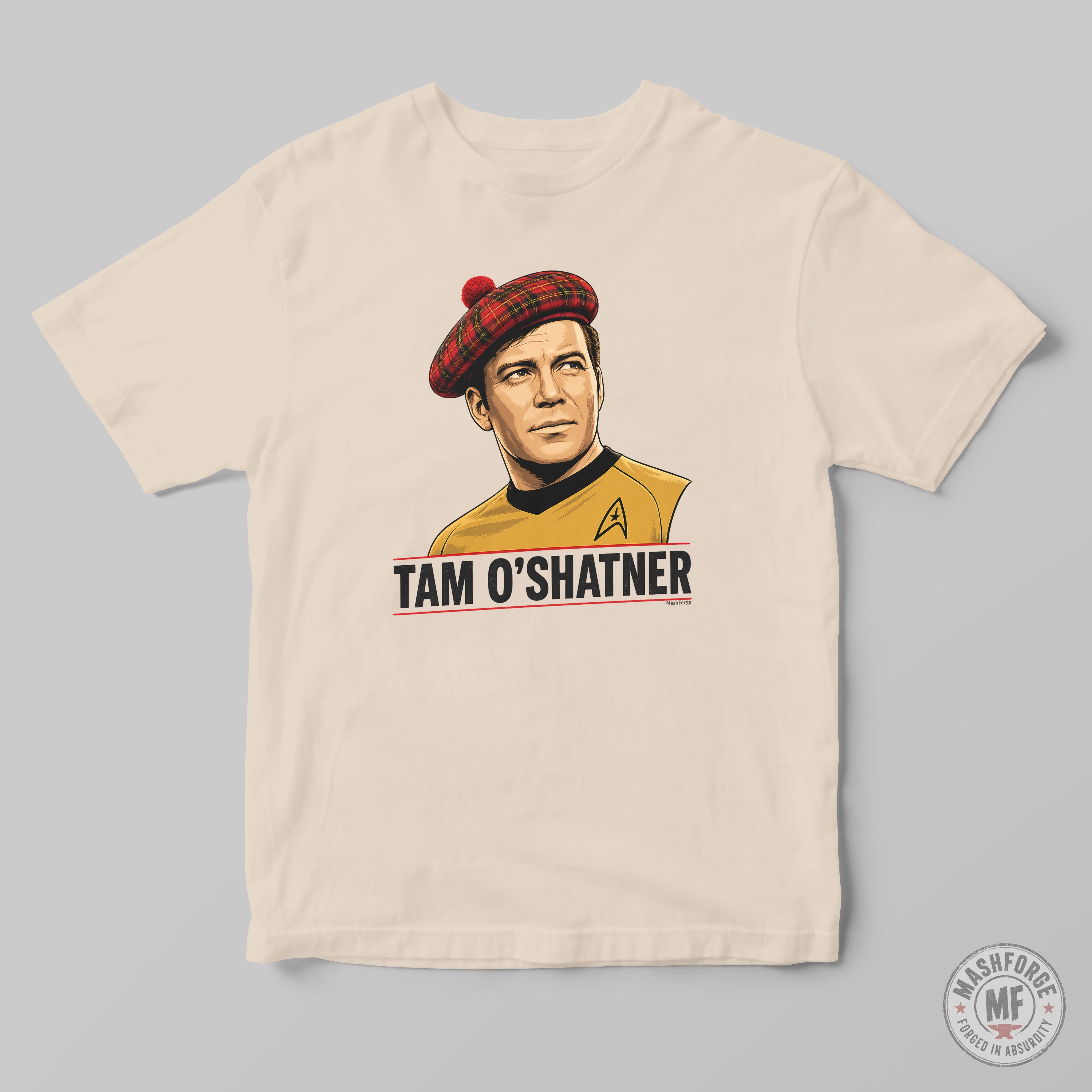A cream-colored crewneck t-shirt featuring a graphic print of Captain Tam O'Shatner from Star Trek wearing a red tartan beret and a gold uniform, with the text 'TAM O'SHATNER' printed below. The t-shirt is displayed flat against a neutral gray background.
