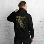 Man wearing a brown hoodie with a graphic and text beetlejuice on the back, against a white brick wall.