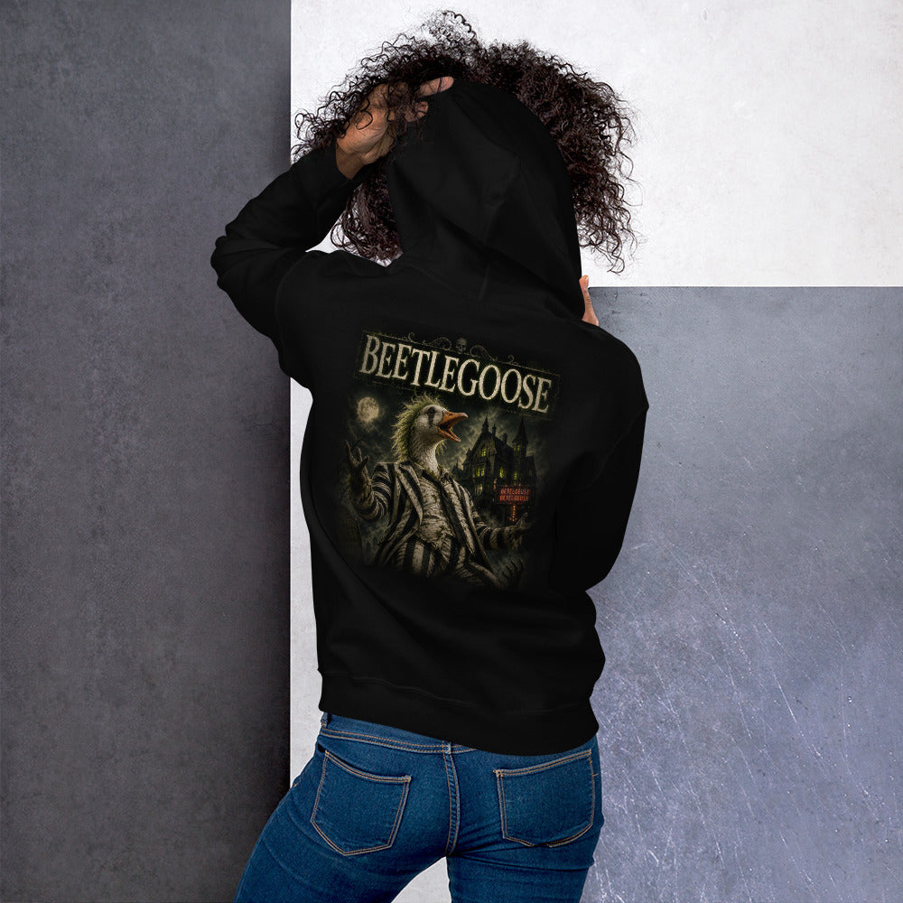 Person wearing a black hoodie and blue jeans against a gray and white wall.