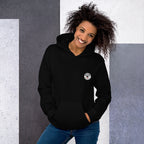 Woman wearing a black hoodie with a mashhforge logo against a gray and white background