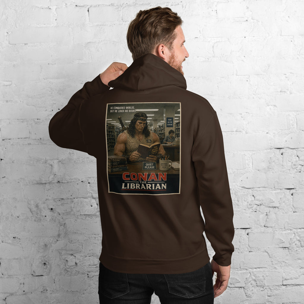 Person wearing a hoodie with 'Conan the Librarian' graphic on the back against a white brick wall.
