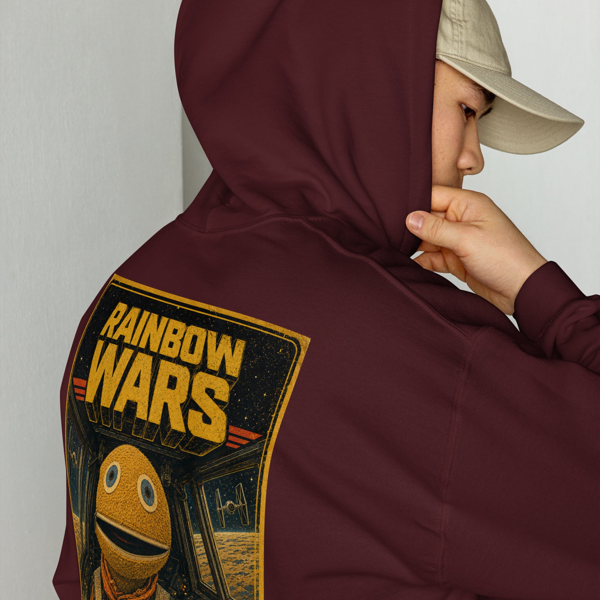 Person wearing a maroon hoodie with 'Rainbow Wars' design on the back.
