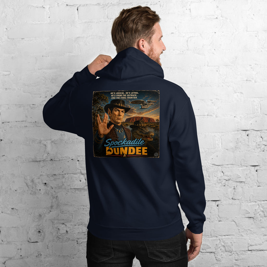 Person wearing a navy hoodie with 'Spookadie Dundee' graphic on the back against a white brick wall.