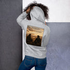 Person wearing a hoodie with a dances with wolves graphic design on the back against a gray background