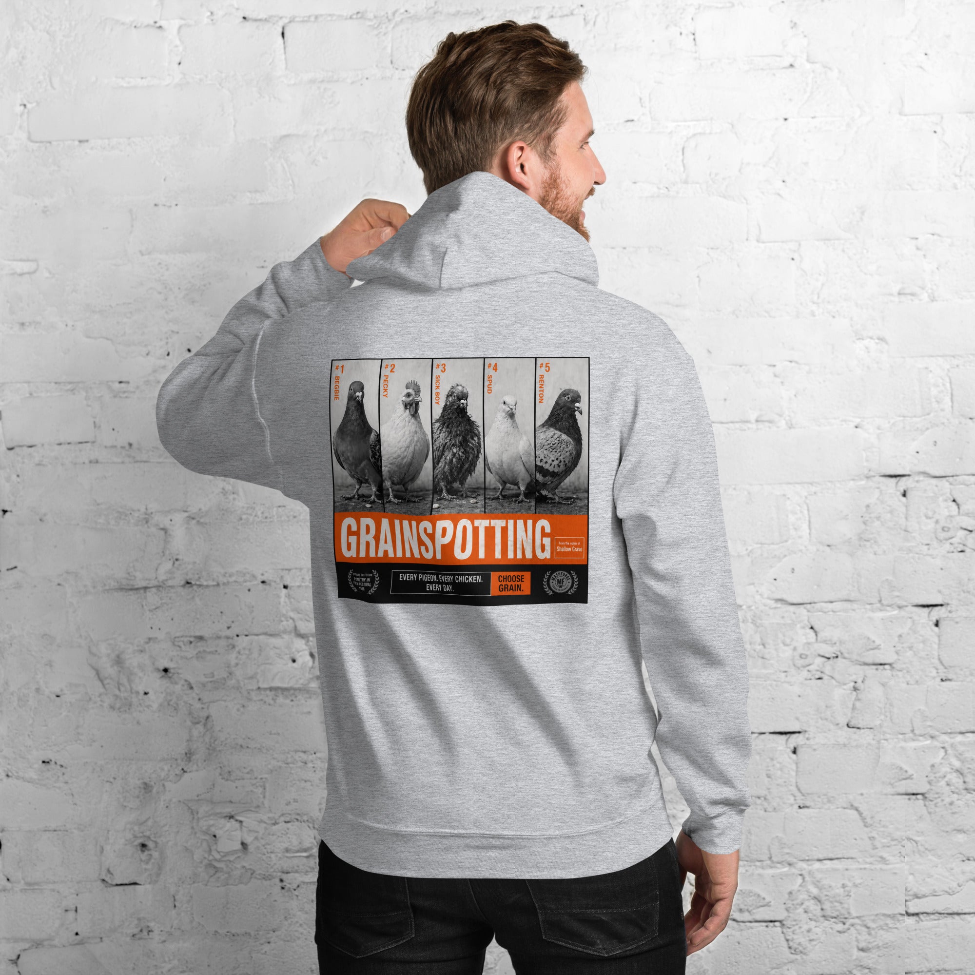 Person wearing a hoodie with 'Grainspotting' graphic on the back against a white brick wall.