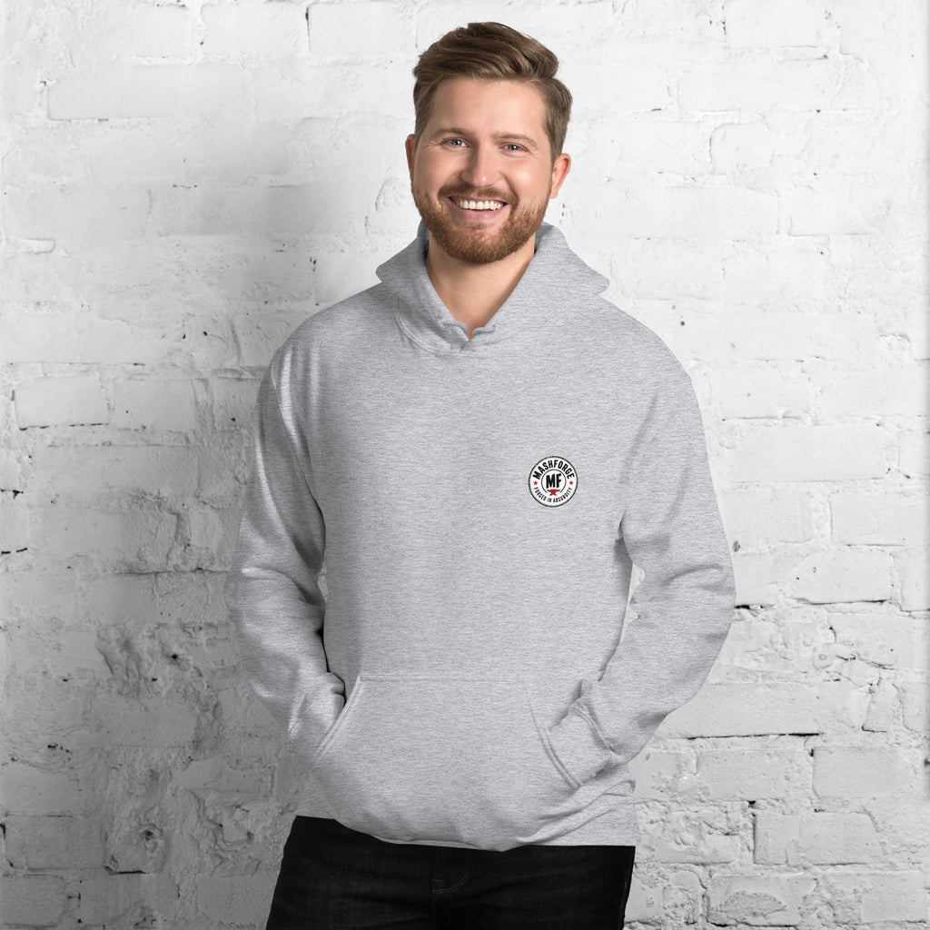 Man wearing a mashforge gray hoodie with 'dog dad' text against a white brick wall.