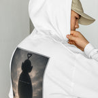 Person wearing a white hoodie with a graphic teletubby design on the back, standing against a plain background.