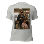 Gray t-shirt with a graphic of a woman getting a haircut and the text 'The Perminator' on a white background.