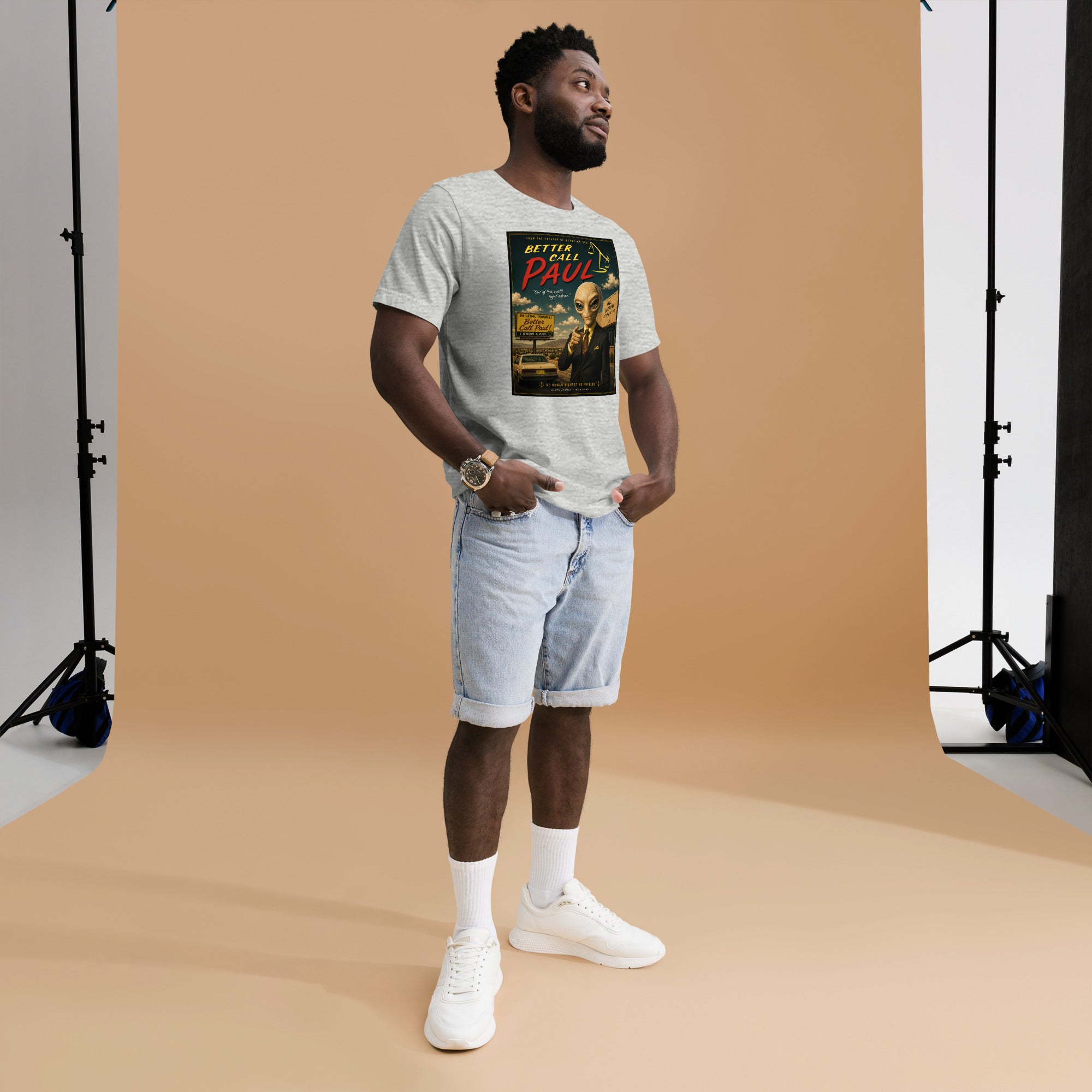 Man wearing a funny mashforge graphic t-shirt and shorts standing against a brown backdrop