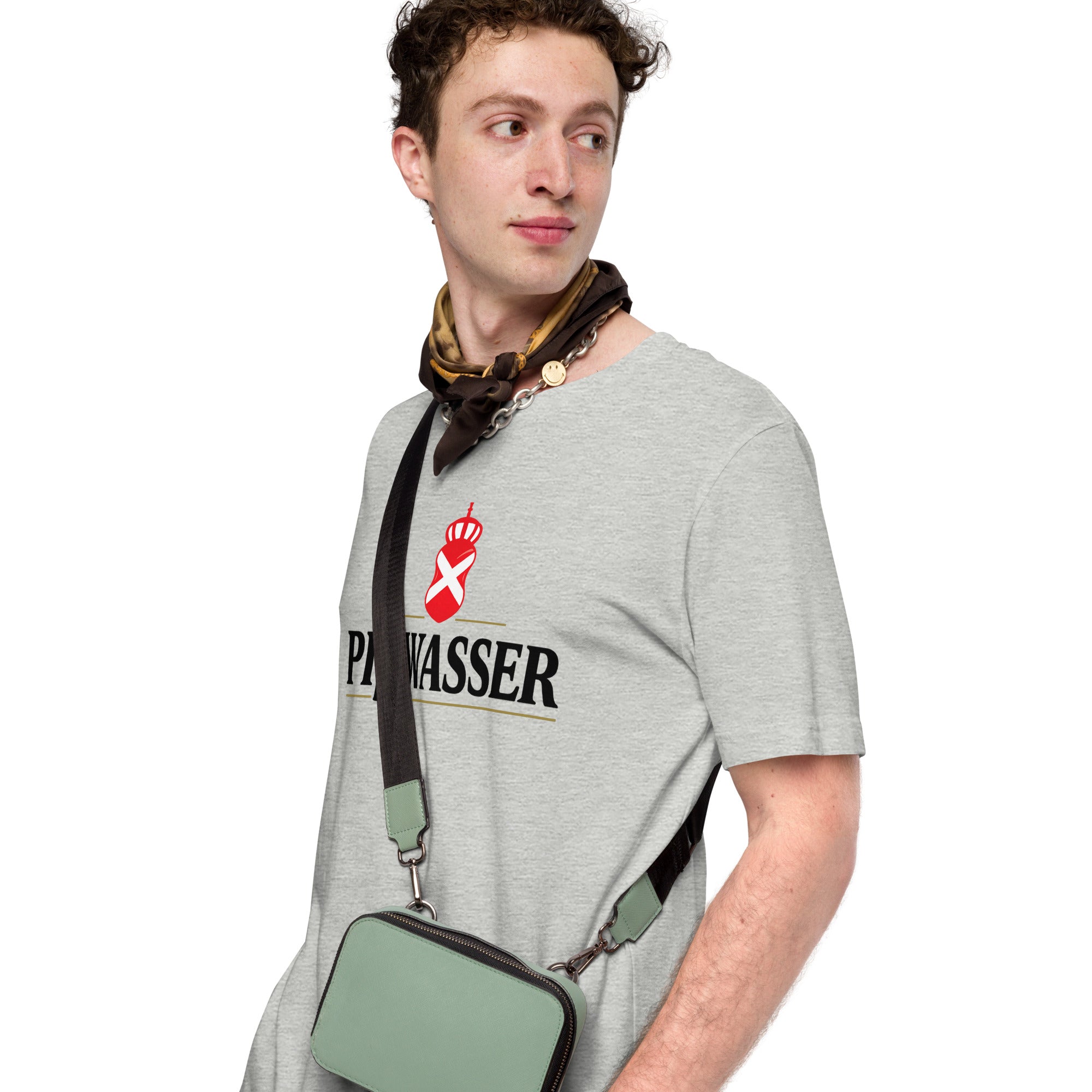 A man wearing a light gray crewneck t-shirt with a black and red 'PiBWASSER' logo on the chest, styled with a patterned neck scarf and a sage green crossbody bag with a black strap.