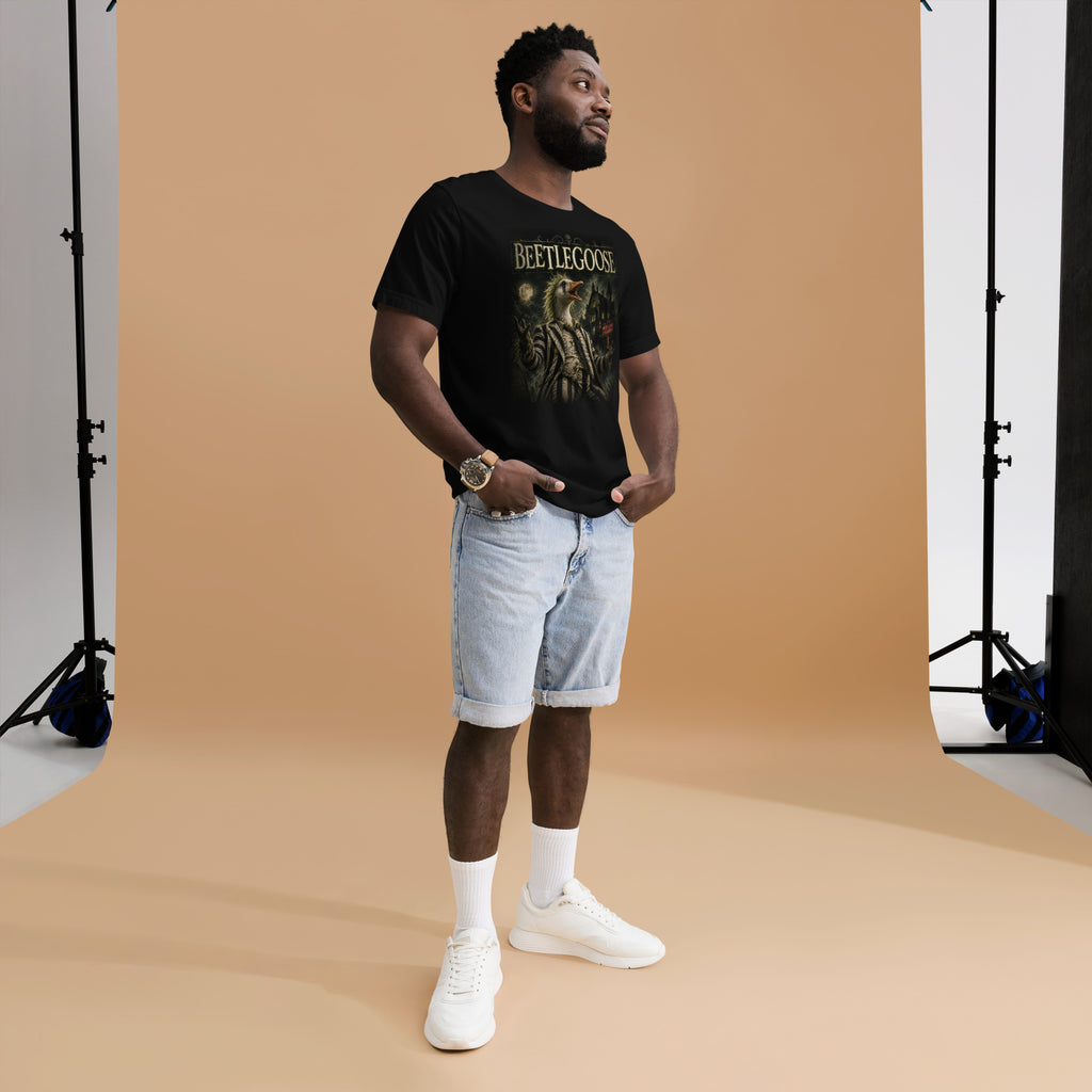 Man wearing a funny black t-shirt with text, light blue shorts, and white sneakers in a studio setting.