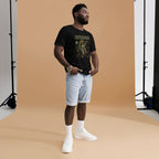 Man wearing a funny black t-shirt with text, light blue shorts, and white sneakers in a studio setting.