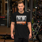 Man wearing a black t-shirt with 'Grainspotting' graphic in a gym setting