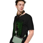 Man wearing a black t-shirt with a graphic design and holding a green bag on a white background