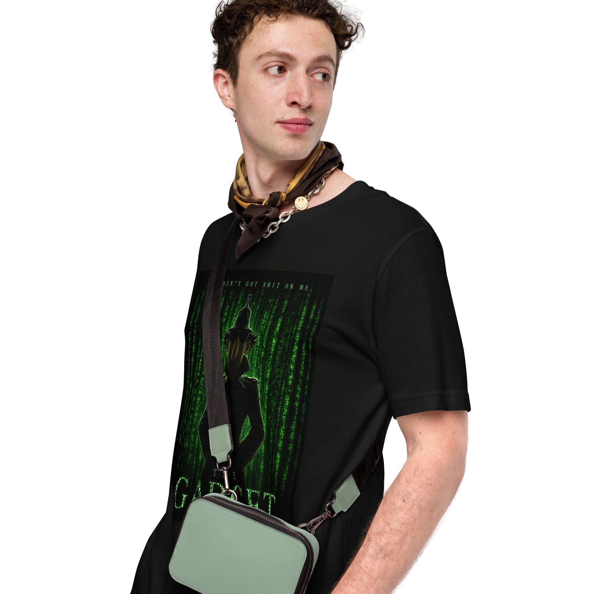 Man wearing a black t-shirt with a graphic design and holding a green bag on a white background