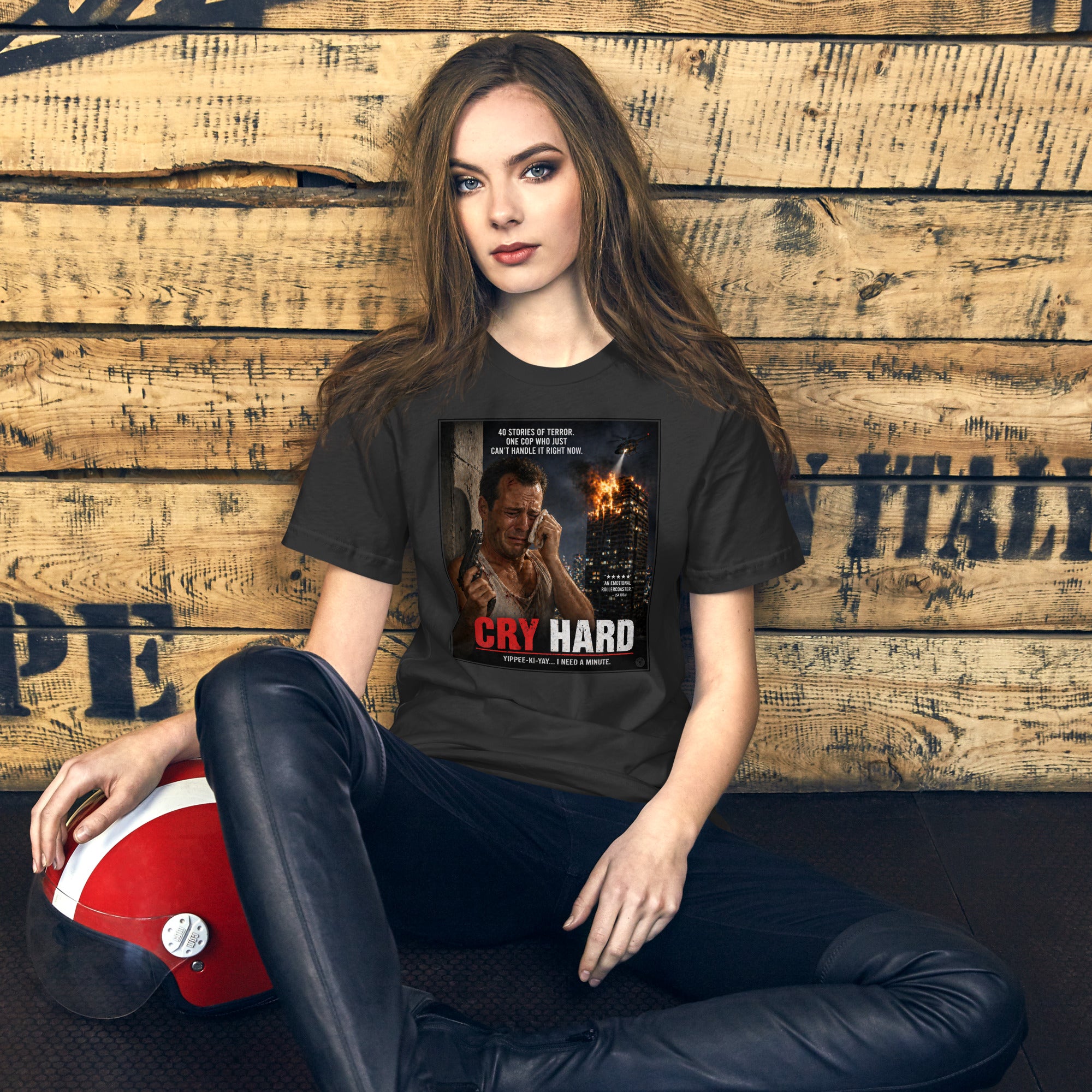 Woman wearing a t-shirt with 'Cry Hard' graphic design against a wooden background