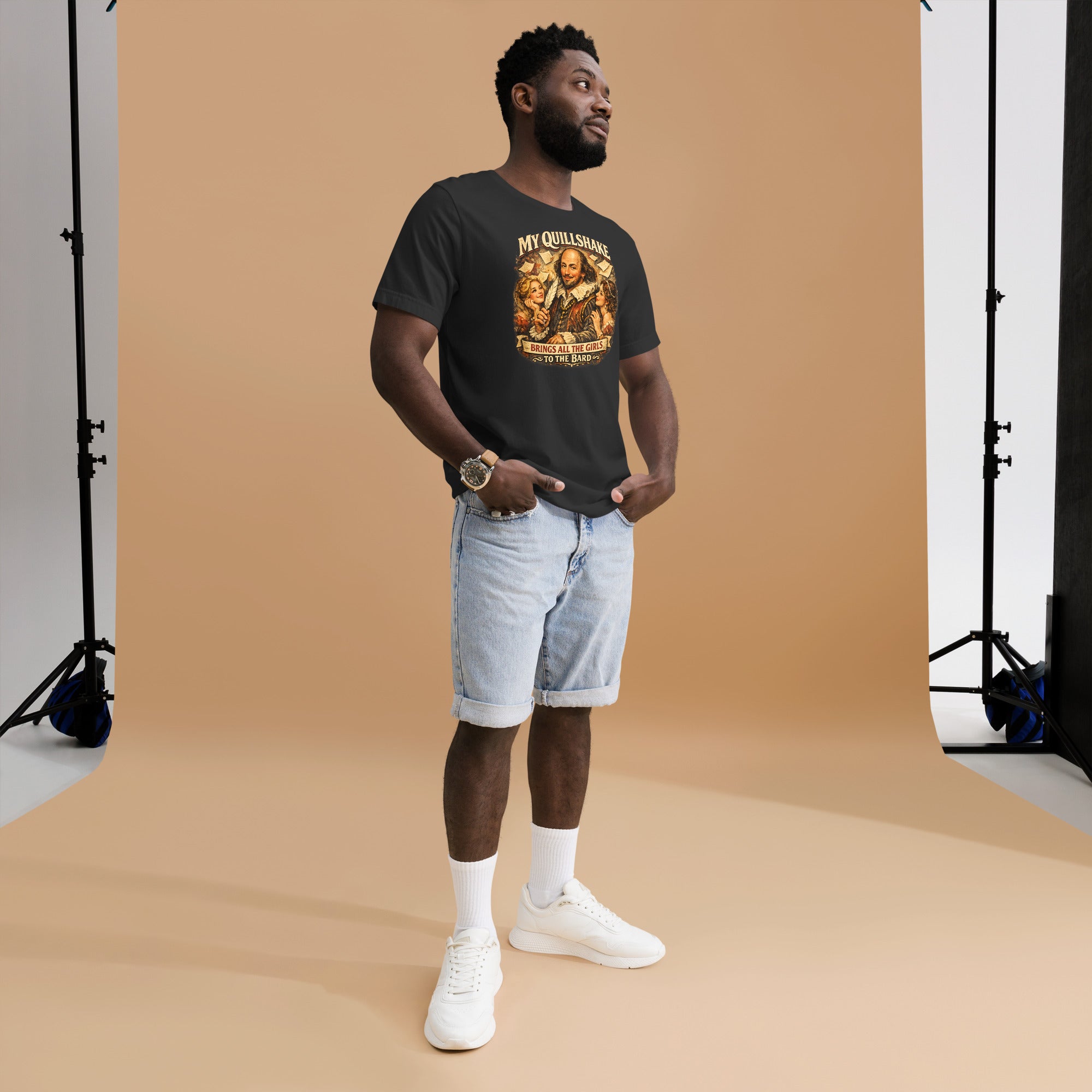 Man wearing a graphic t-shirt and shorts standing against a brown backdrop