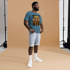 Man wearing a blue t-shirt with a graphic design, standing against a brown backdrop.