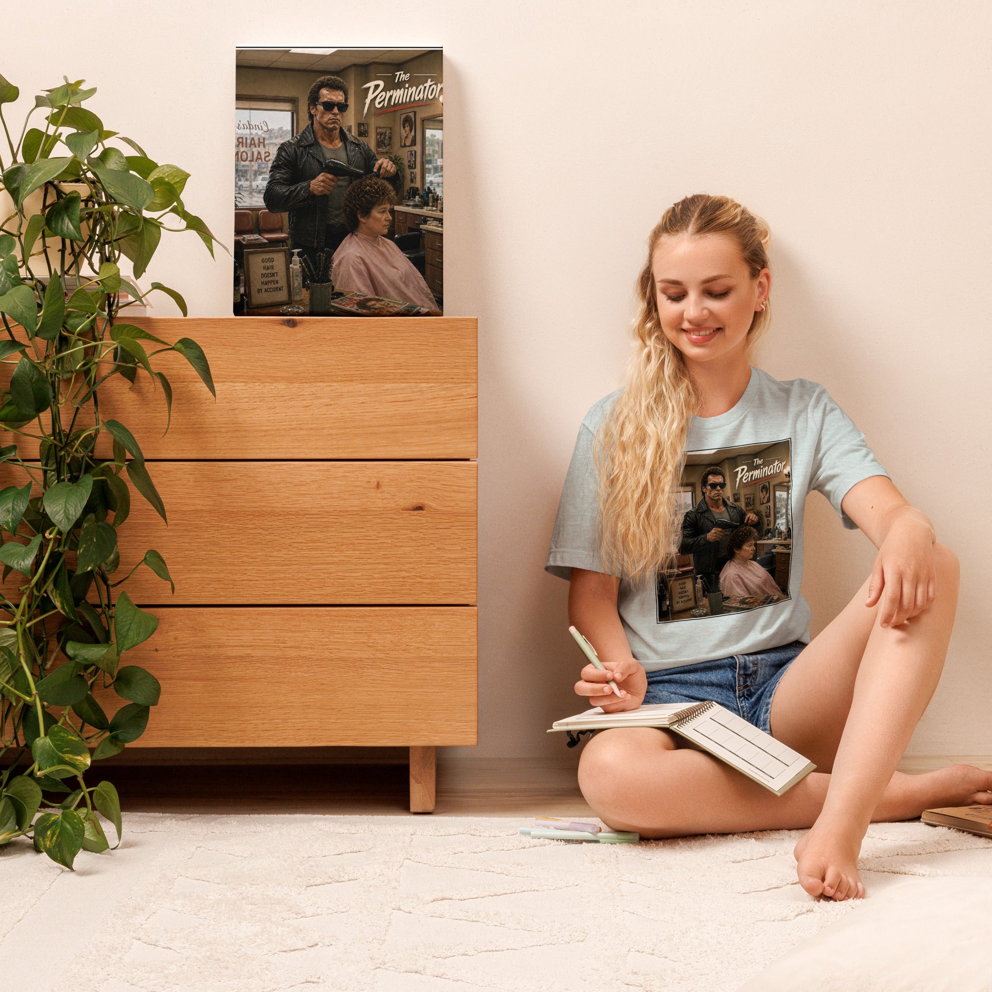 Woman sitting on the floor reading a book with a wooden dresser and plant in the background
