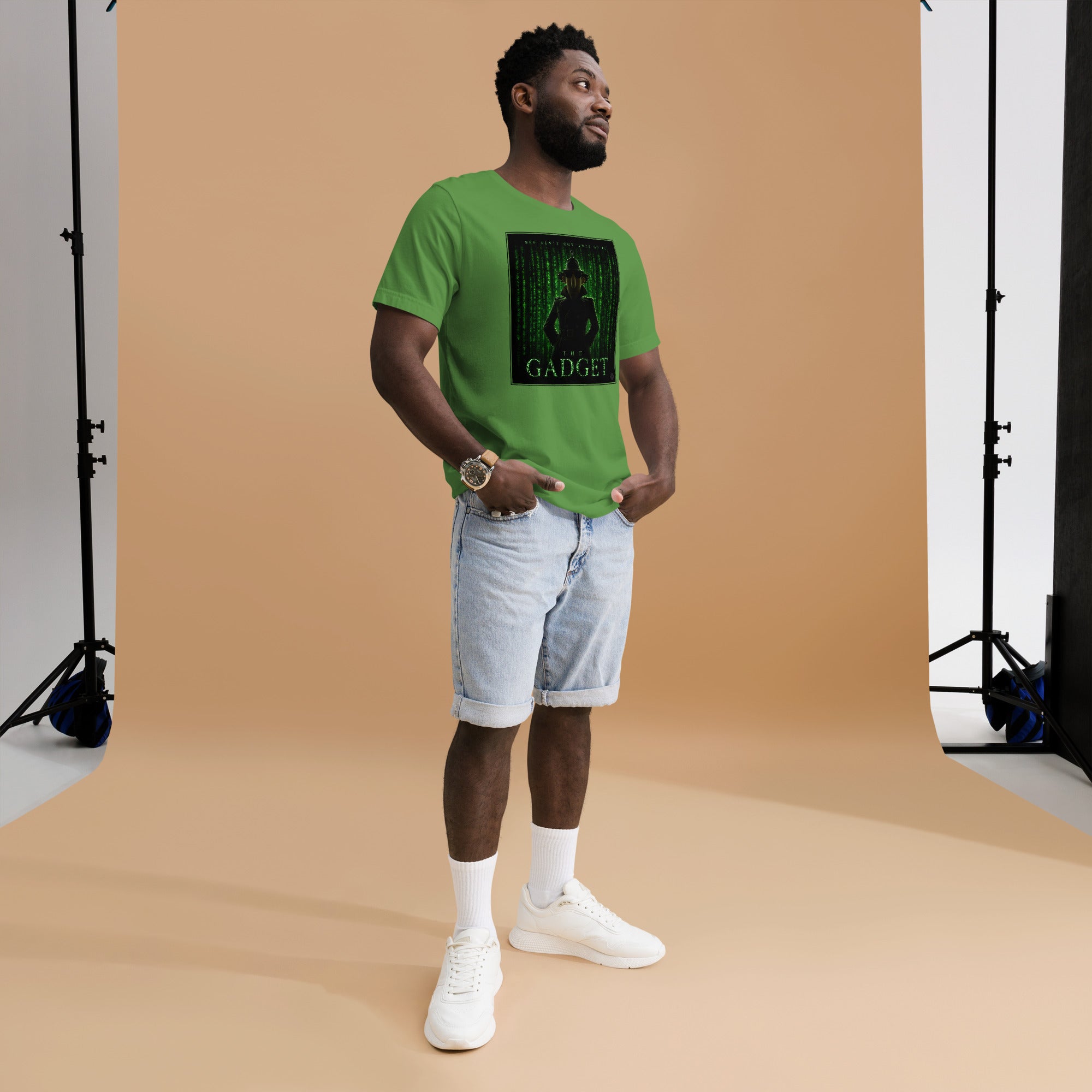 Man wearing a green mashforge t-shirt with a matrix style graphic design on a brown backdrop