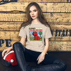 Woman wearing a mashforge t-shirt sitting against a wooden wall.