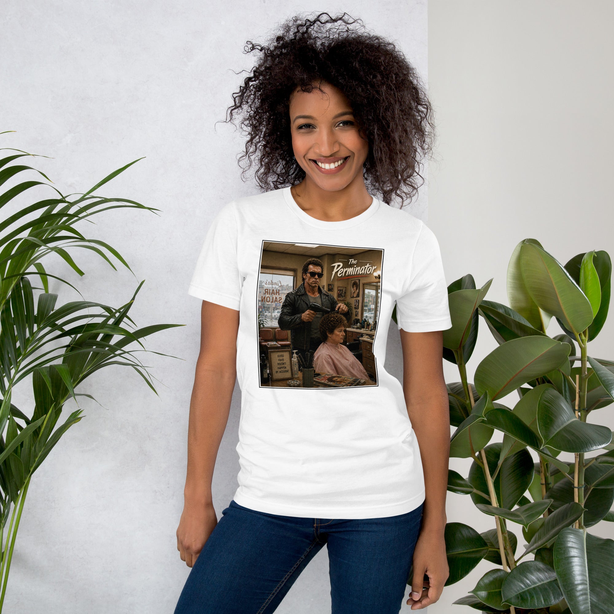Person wearing a white t-shirt with a funny cool  graphic design, standing between two plants against a light background