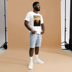 Man wearing a white t-shirt with a graphic design in a studio setting