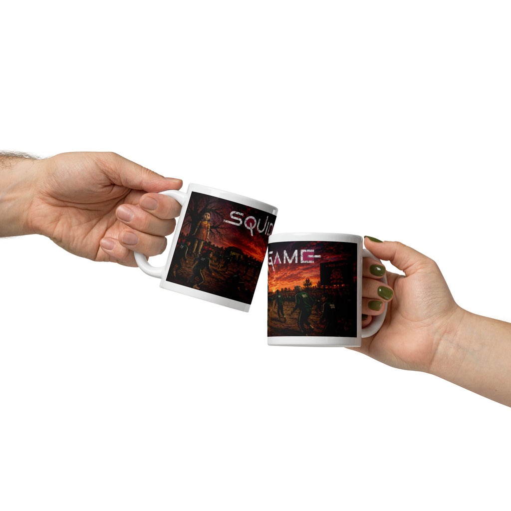Two hands holding mugs with 'Squid Game' design on a white background