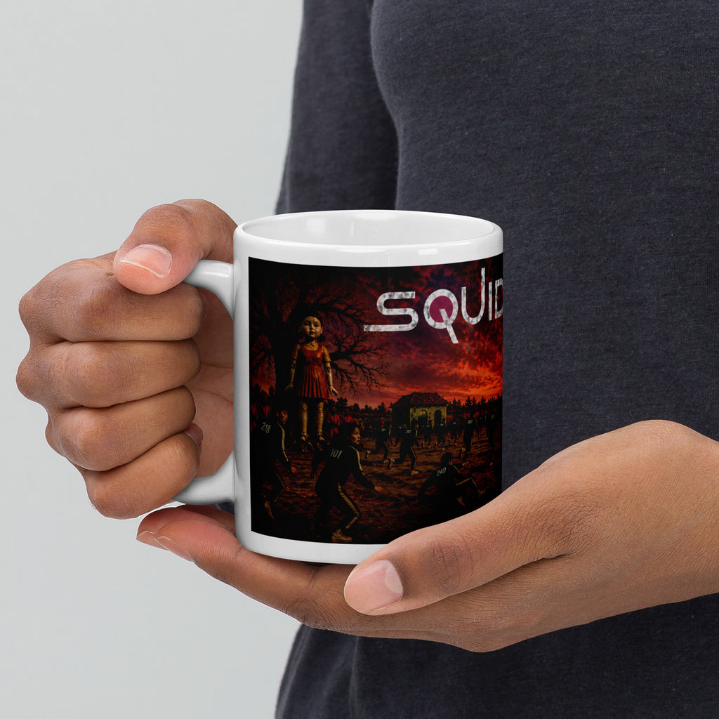 Person holding a mug with a 'Squid' design on a plain background